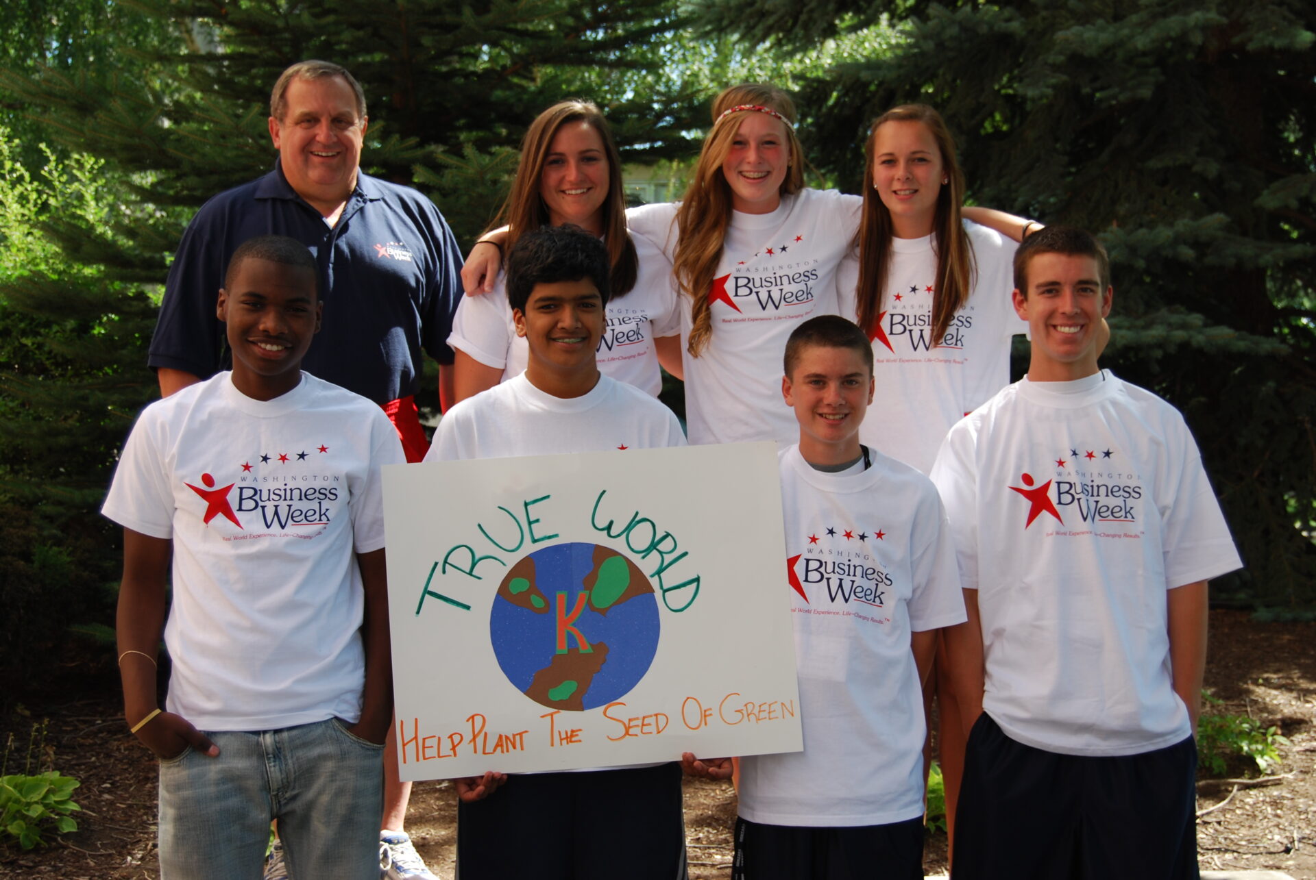 A group of students stand with AWB's president.